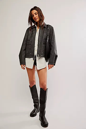 Free People Blaire Vegan Leather Jacket made from smooth, high-quality faux leather with a sleek, fitted design. This jacket features a zip-up front, classic collar, and minimalistic details, offering an edgy, versatile look that pairs perfectly with both casual and dressy outfits, Charcoal Combo