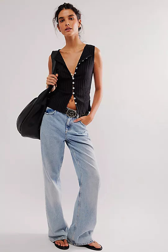 Free People Tilly Vest made from a soft, textured fabric with a relaxed, sleeveless design. This button-front vest offers a stylish and lightweight layering piece, perfect for adding a chic touch to any outfit, Black