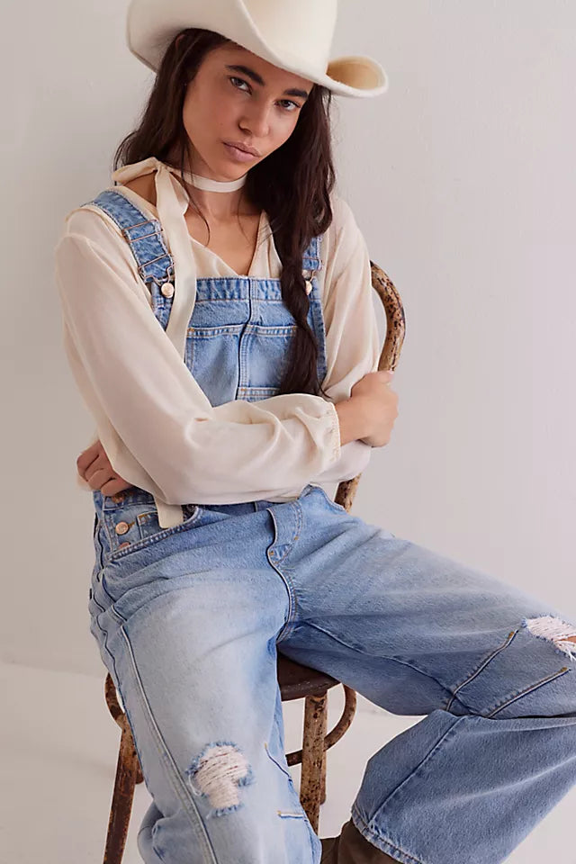 We The Free Good Luck Barrel Overalls with a relaxed, loose-fit design and wide-leg silhouette. These overalls feature adjustable straps and a soft, distressed denim fabric, offering a casual, boho-inspired look with a comfortable, laid-back feel, Going Steady