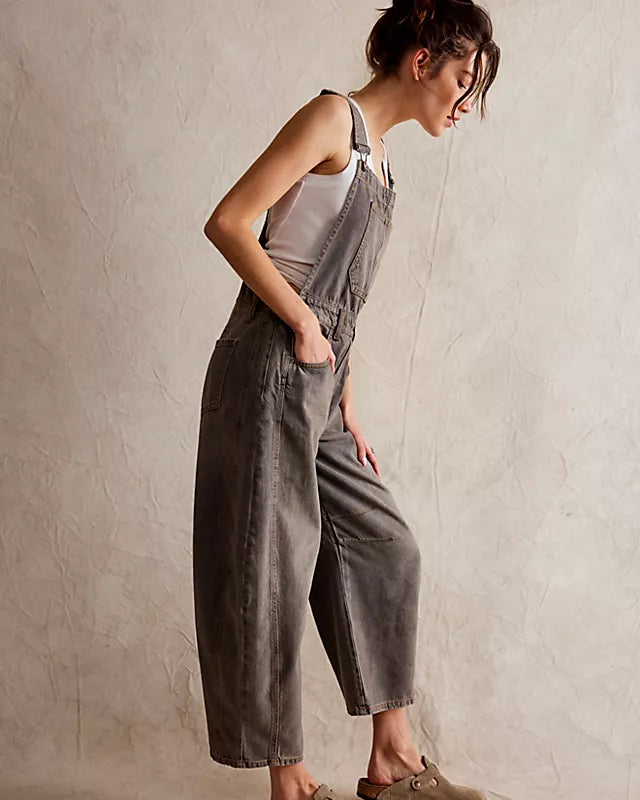 We The Free Good Luck Barrel Overalls with a relaxed, loose-fit design and wide-leg silhouette. These overalls feature adjustable straps and a soft, distressed denim fabric, offering a casual, boho-inspired look with a comfortable, laid-back feel, Archive Grey