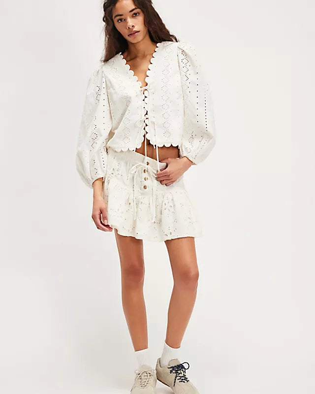 Free People Roselle Eyelet Mini Skirt – A feminine mini skirt featuring delicate eyelet detailing, a high waist, and a flattering, A-line silhouette for a light and breezy look, Ivory