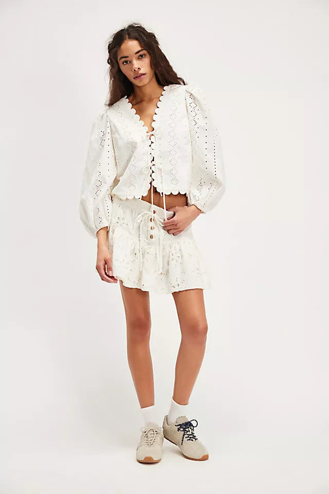 Free People Roselle Eyelet Mini Skirt – A feminine mini skirt featuring delicate eyelet detailing, a high waist, and a flattering, A-line silhouette for a light and breezy look, Ivory