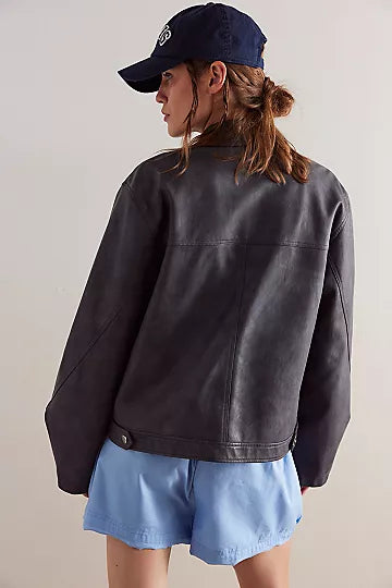 Free People Blaire Vegan Leather Jacket made from smooth, high-quality faux leather with a sleek, fitted design. This jacket features a zip-up front, classic collar, and minimalistic details, offering an edgy, versatile look that pairs perfectly with both casual and dressy outfits, Charcoal Combo