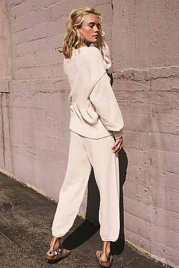 Free People Hailee Cardi Set featuring a soft, knit fabric with a relaxed fit. The set includes a long-sleeve, open-front cardigan and matching knit pants, offering a cozy and stylish look, perfect for casual wear or lounging, Powder Sand