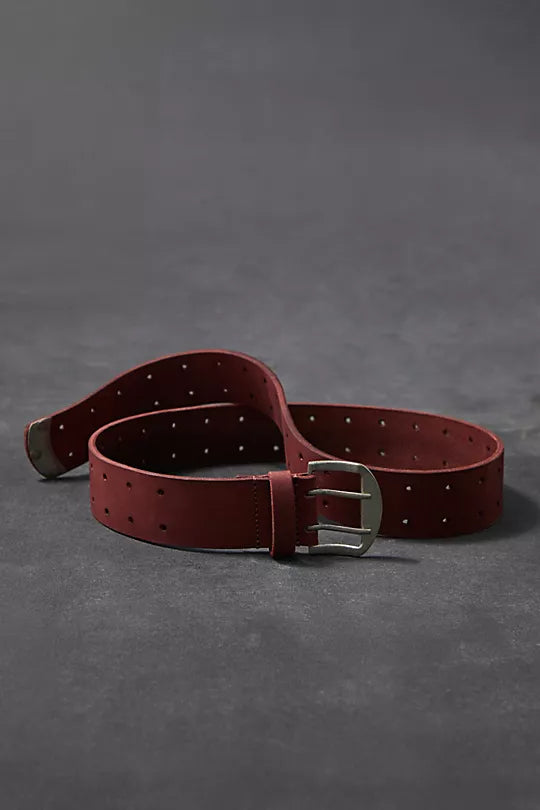 We The Free Double Cross Belt made from distressed leather with a bold, double-cross buckle design. This adjustable belt adds a rustic, boho-inspired touch to any outfit, perfect for pairing with jeans or dresses, Oxblood