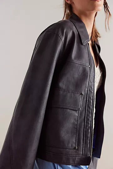 Free People Blaire Vegan Leather Jacket made from smooth, high-quality faux leather with a sleek, fitted design. This jacket features a zip-up front, classic collar, and minimalistic details, offering an edgy, versatile look that pairs perfectly with both casual and dressy outfits, Charcoal Combo