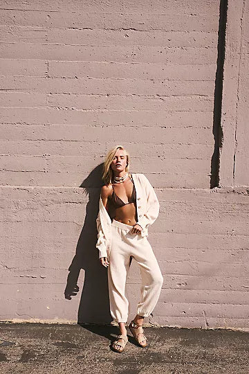 Free People Hailee Cardi Set featuring a soft, knit fabric with a relaxed fit. The set includes a long-sleeve, open-front cardigan and matching knit pants, offering a cozy and stylish look, perfect for casual wear or lounging, Powder Sand
