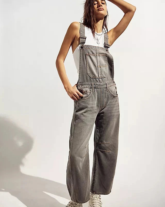 We The Free Good Luck Barrel Overalls with a relaxed, loose-fit design and wide-leg silhouette. These overalls feature adjustable straps and a soft, distressed denim fabric, offering a casual, boho-inspired look with a comfortable, laid-back feel, Archive Grey