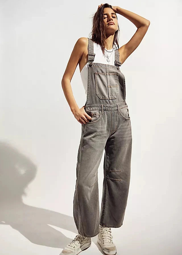 We The Free Good Luck Barrel Overalls with a relaxed, loose-fit design and wide-leg silhouette. These overalls feature adjustable straps and a soft, distressed denim fabric, offering a casual, boho-inspired look with a comfortable, laid-back feel, Archive Grey