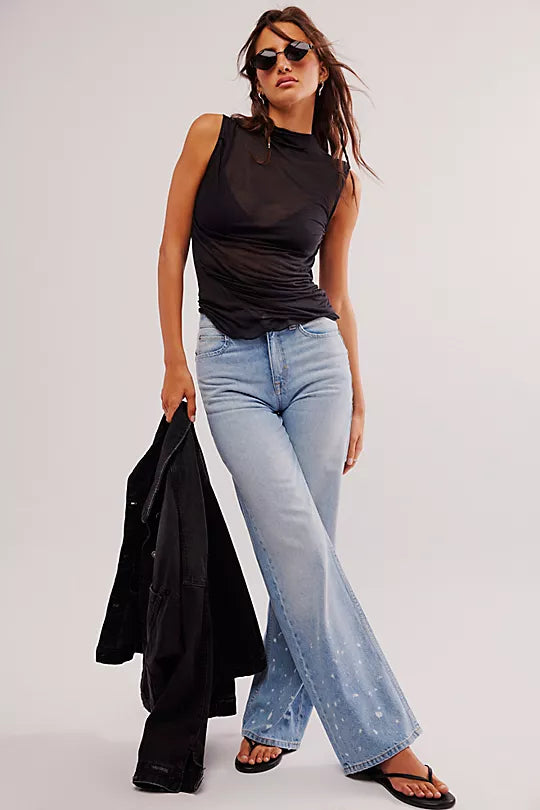 Free People On Air Muscle Tank with a mock neckline, ruched sides, and semi-sheer featherweight fabric in a drapey, form-fitting silhouette, Black