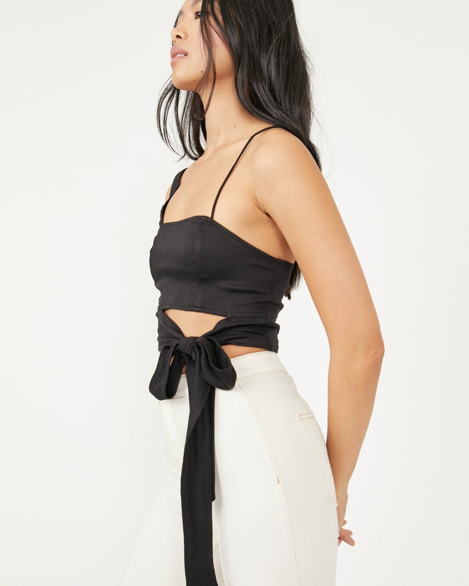 Free People Mila Top – A fitted top with adjustable shoulder straps, smocking at the back, darting at the front, and a cutout at the bottom front, Black