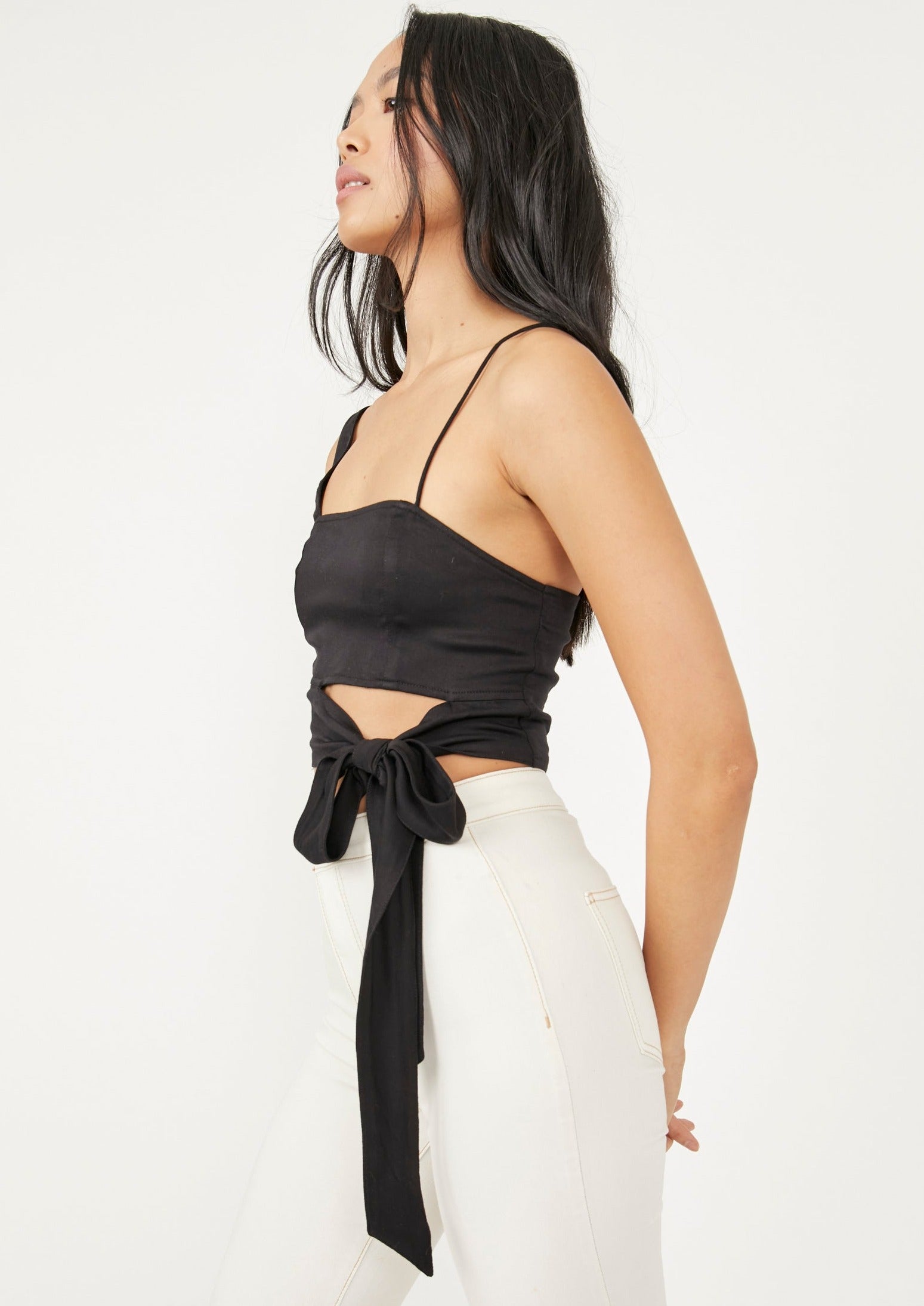 Free People Mila Top – A fitted top with adjustable shoulder straps, smocking at the back, darting at the front, and a cutout at the bottom front, Black
