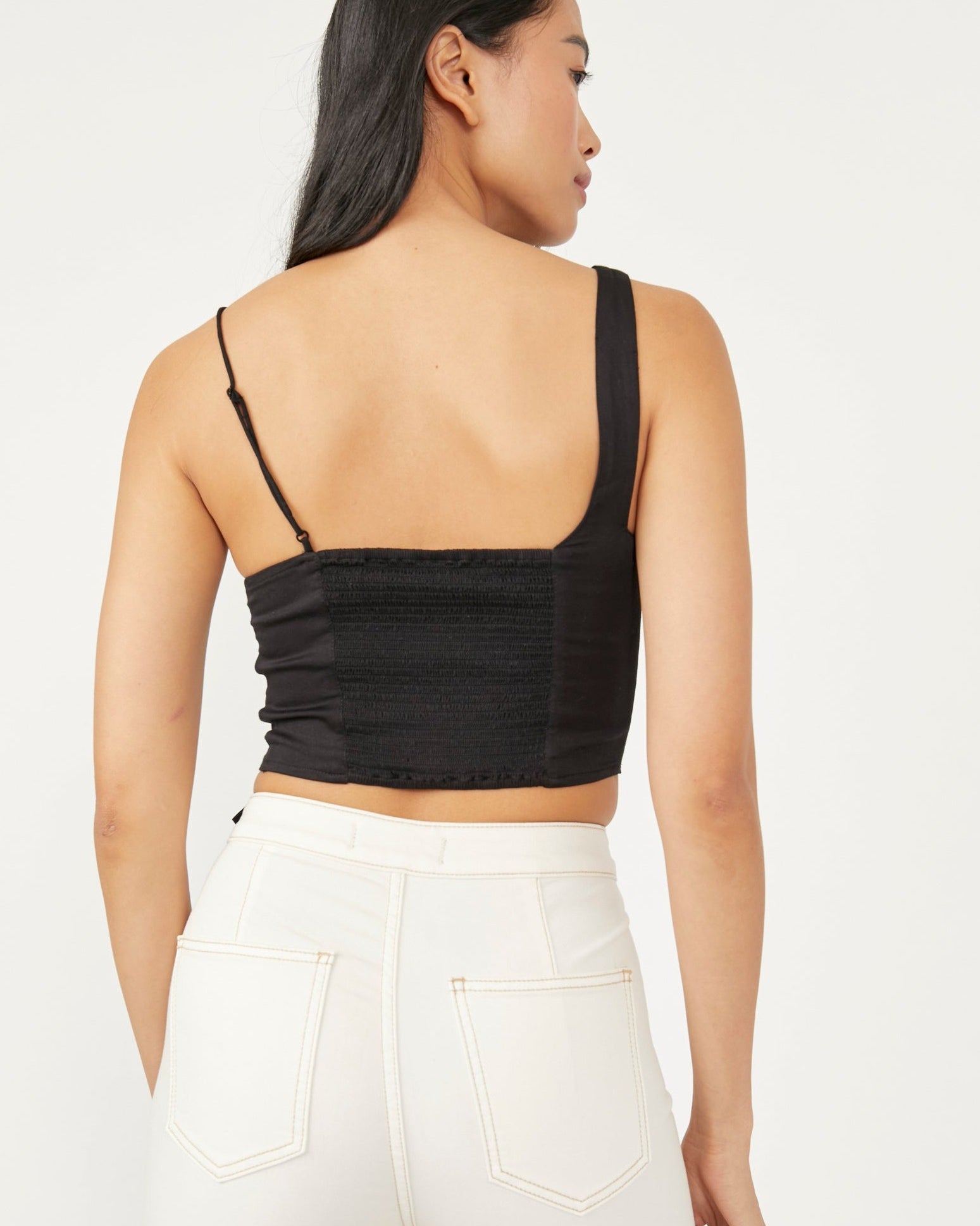 Free People Mila Top – A fitted top with adjustable shoulder straps, smocking at the back, darting at the front, and a cutout at the bottom front, Black