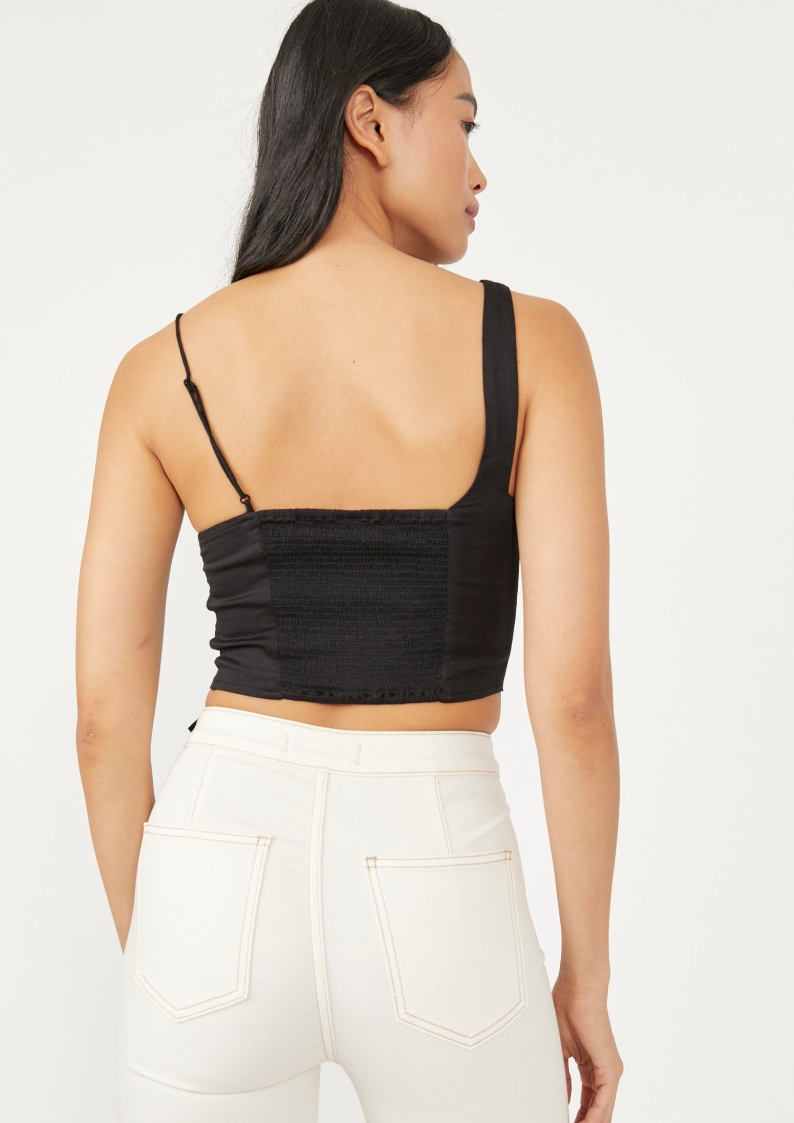 Free People Mila Top – A fitted top with adjustable shoulder straps, smocking at the back, darting at the front, and a cutout at the bottom front, Black