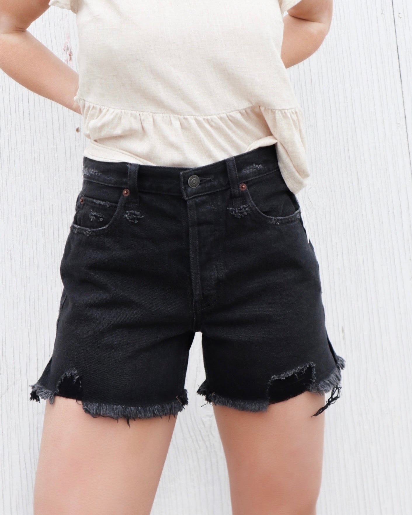 Free People Makai Cutoff Shorts – High-waisted denim shorts with a frayed hem, offering a relaxed fit and a vintage-inspired style for a casual, laid-back look, Washed Black