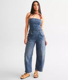Free People Je Suis Prêt Denim Barrel Jumpsuit – a slim-fit jumpsuit with a corset-inspired bodice, tapered barrel leg, removable straps, five-pocket design, and smocking at the back, Petit Blue