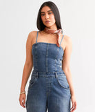 Free People Je Suis Prêt Denim Barrel Jumpsuit – a slim-fit jumpsuit with a corset-inspired bodice, tapered barrel leg, removable straps, five-pocket design, and smocking at the back, Petit Blue