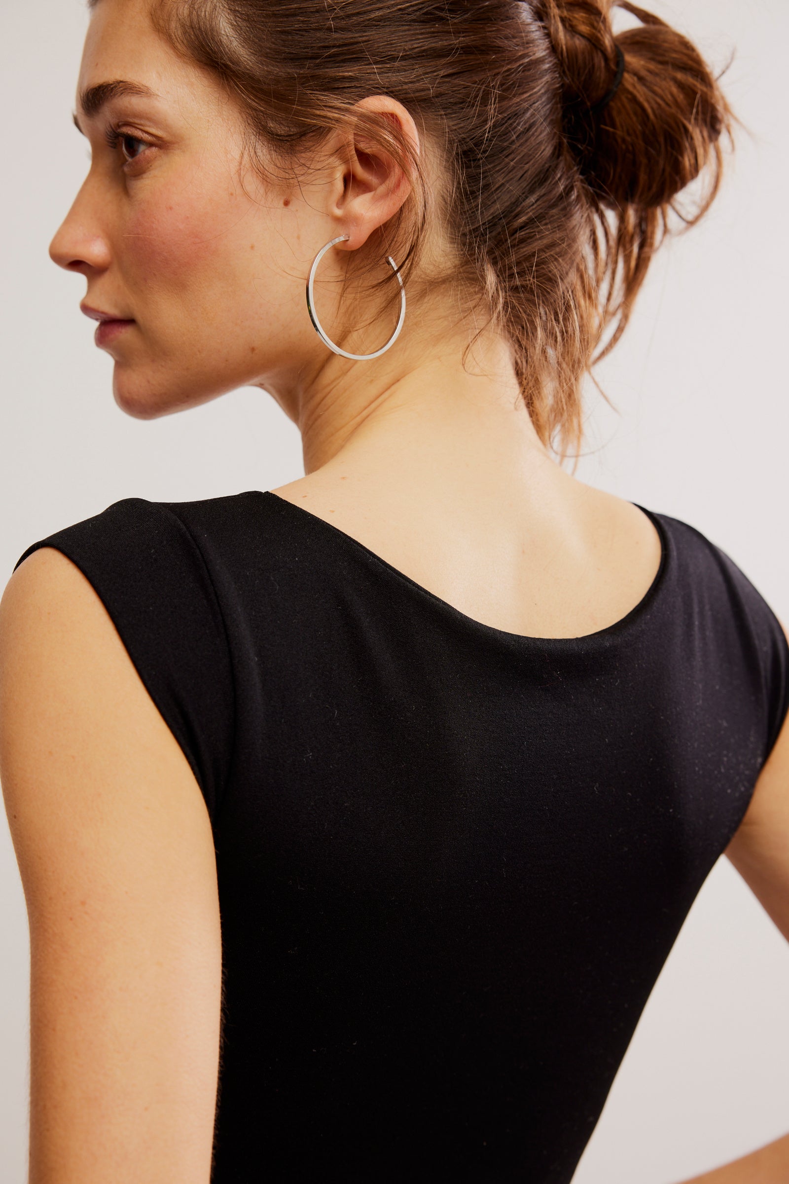 Free People Clean Line Boatneck Bodysuit with short sleeves, a boatneck neckline, and a sleek, fitted design for a comfortable, flattering look, Black