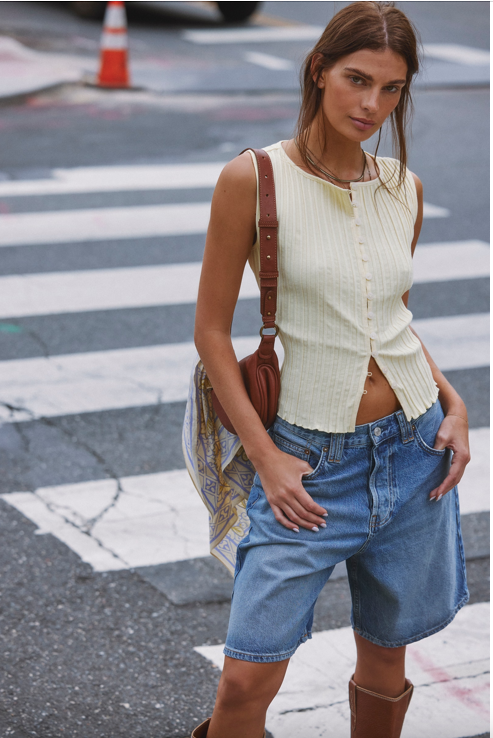 Free People Palmer Crossbody bag made from soft leather with a smooth, polished finish. This compact bag features an adjustable strap and a zippered main compartment, offering a stylish and functional accessory for everyday use, Spiced Rum