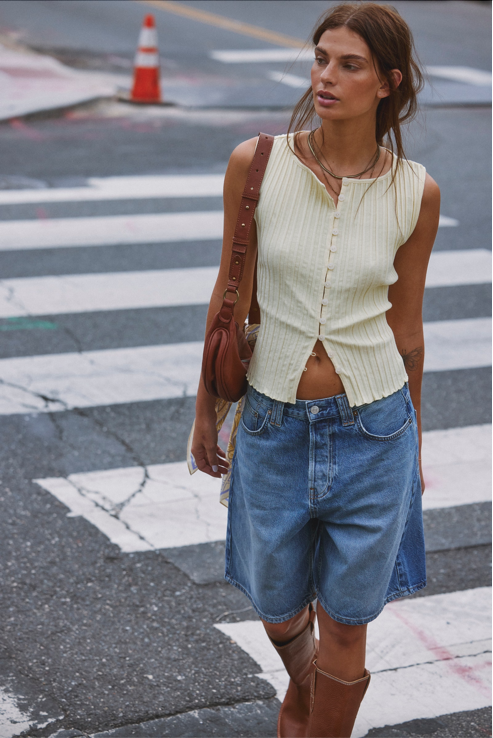 Free People Palmer Crossbody bag made from soft leather with a smooth, polished finish. This compact bag features an adjustable strap and a zippered main compartment, offering a stylish and functional accessory for everyday use, Spiced Rum