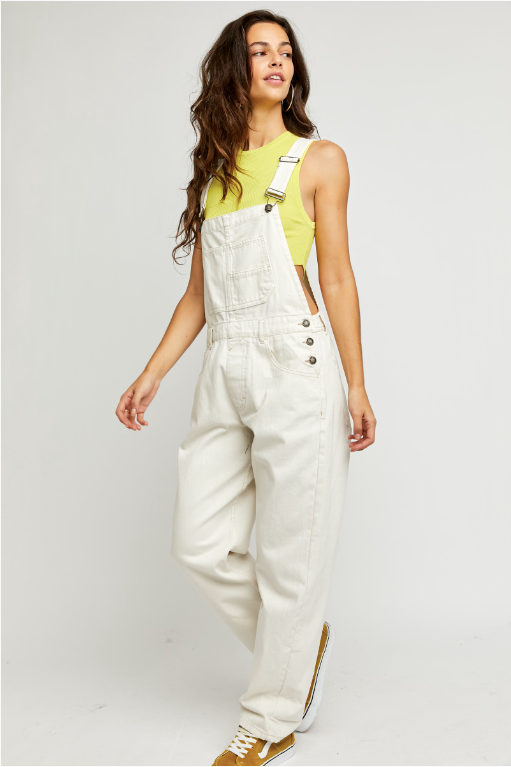 We The Free Ziggy Denim Overalls featuring a relaxed, vintage-inspired fit with wide legs and a distressed, worn-in look. The overalls have adjustable shoulder straps, a front bib pocket, and a button-up closure, offering both style and comfort for everyday wear, Parchment