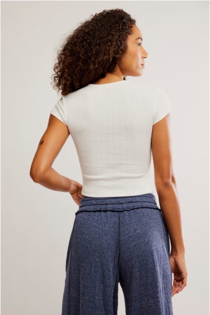 Free People Wait a Minute Baby Tee with a cropped, fitted design, short sleeves, and a soft, stretchy fabric, Oatmeal