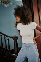 Free People Wait a Minute Baby Tee with a cropped, fitted design, short sleeves, and a soft, stretchy fabric, Oatmeal