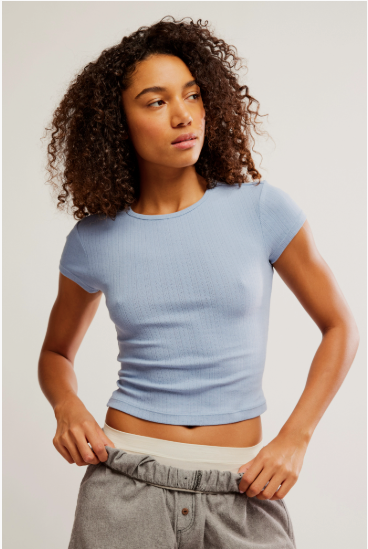 Free People Wait a Minute Baby Tee with a cropped, fitted design, short sleeves, and a soft, stretchy fabric, Soft Chambray