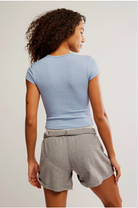Free People Wait a Minute Baby Tee with a cropped, fitted design, short sleeves, and a soft, stretchy fabric, Soft Chambray