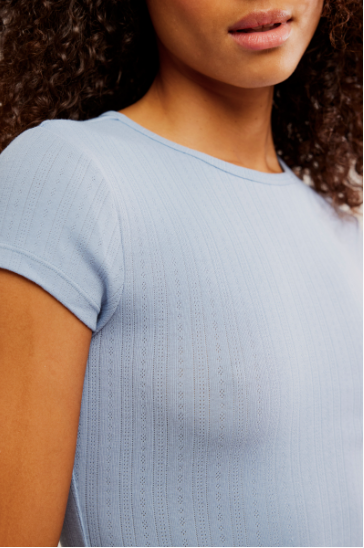 Free People Wait a Minute Baby Tee with a cropped, fitted design, short sleeves, and a soft, stretchy fabric, Soft Chambray