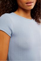 Free People Wait a Minute Baby Tee with a cropped, fitted design, short sleeves, and a soft, stretchy fabric, Soft Chambray