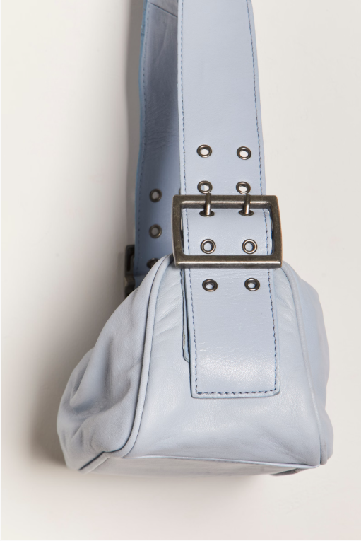 Free People Arm Candy Bag in luxe leather with a thick adjustable strap, rivet detailing, and a zip-top closure, Chambray