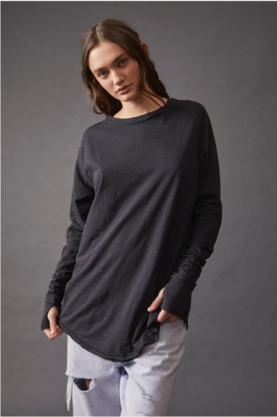 Free People Arden Tee — a slouchy, oversized lightweight long-sleeve tee featuring unfinished trim, thumb holes on the cuffs, and a rounded hem for a relaxed, effortless style, Black