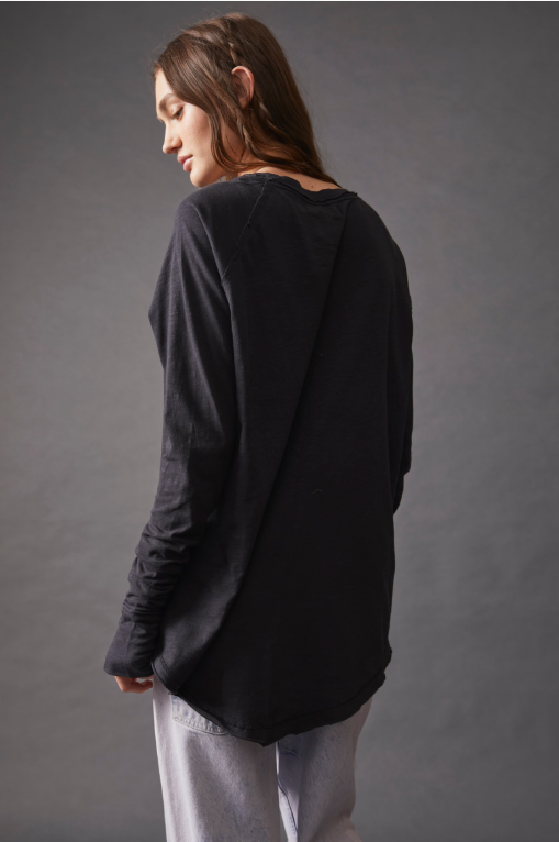 Free People Arden Tee — a slouchy, oversized lightweight long-sleeve tee featuring unfinished trim, thumb holes on the cuffs, and a rounded hem for a relaxed, effortless style, Black