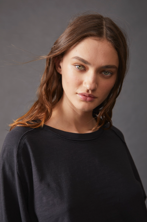 Free People Arden Tee — a slouchy, oversized lightweight long-sleeve tee featuring unfinished trim, thumb holes on the cuffs, and a rounded hem for a relaxed, effortless style, Black