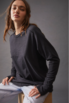 Free People Arden Tee — a slouchy, oversized lightweight long-sleeve tee featuring unfinished trim, thumb holes on the cuffs, and a rounded hem for a relaxed, effortless style, Black