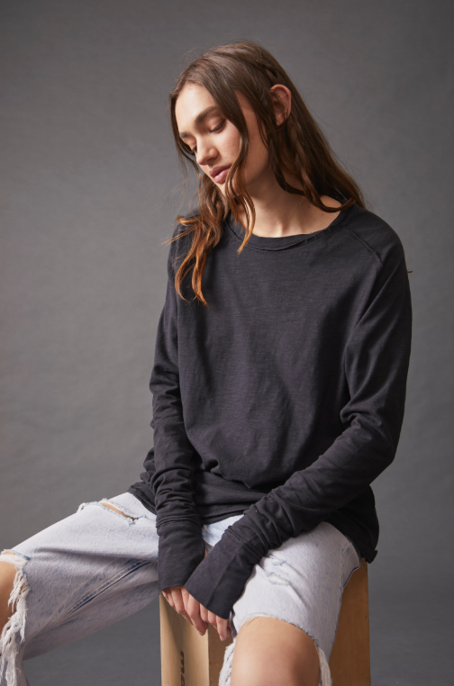 Free People Arden Tee — a slouchy, oversized lightweight long-sleeve tee featuring unfinished trim, thumb holes on the cuffs, and a rounded hem for a relaxed, effortless style, Black