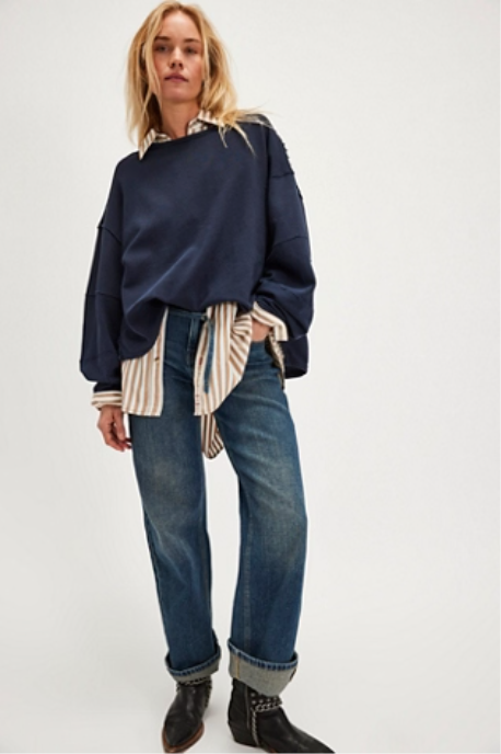 "We The Free Total Eclipse Tee" in an oversized, long-sleeve ribbed cotton fabric. The shirt features a wide scoop neckline, dropped shoulders, and exposed raw seams, Deeper Iris