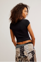 Free People Wait a Minute Baby Tee with a cropped, fitted design, short sleeves, and a soft, stretchy fabric, Black