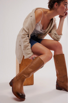 Free People Blaze Pull-On Boots featuring a tall silhouette, square toe, and stacked leather heel with distressed details, Toast Leather