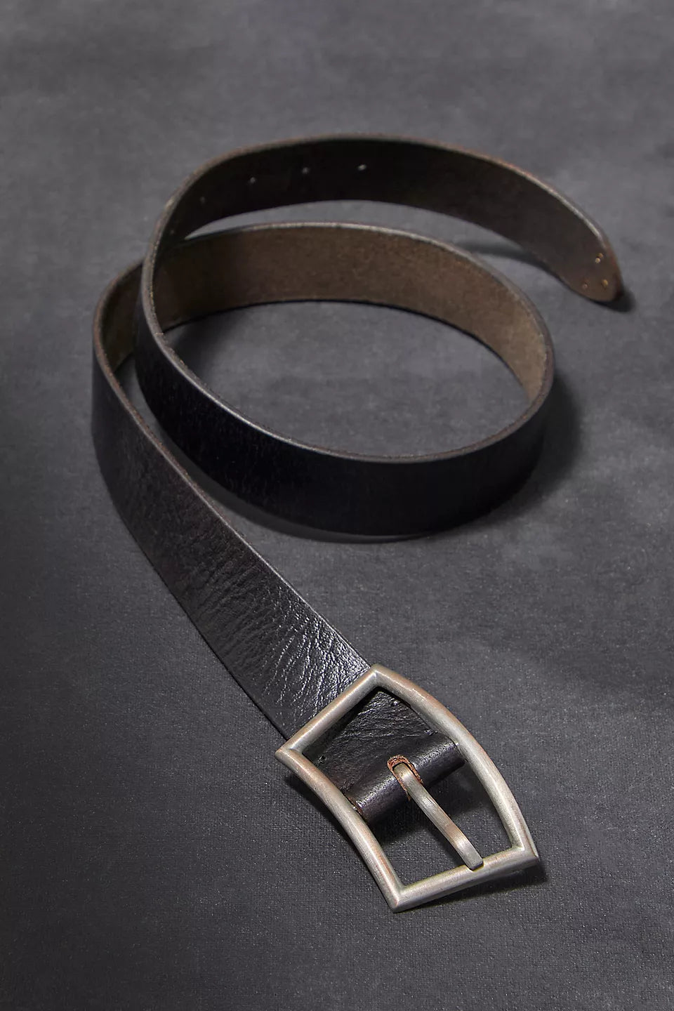 We The Free Essex Belt made from soft, distressed leather with a classic, understated design. This belt features a simple metal buckle and adjustable holes, perfect for adding a touch of rustic style to jeans or dresses, Black