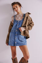 Free People Edie Denim Skirtall – a casual denim skirt with adjustable straps, front pockets, and a button-front design, Blue