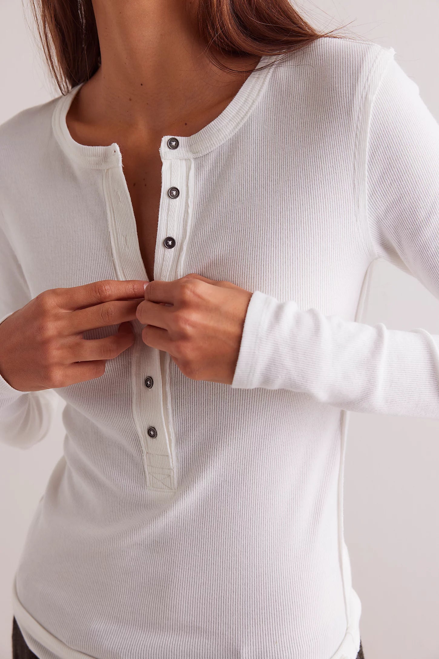 Free People Jamie Henley Top — a fitted, long-sleeve henley-style top featuring soft, stretchy ribbed fabric, a partial button-front closure, scoop neckline, and exposed seam details for a subtly textured, vintage-inspired look, Ivory