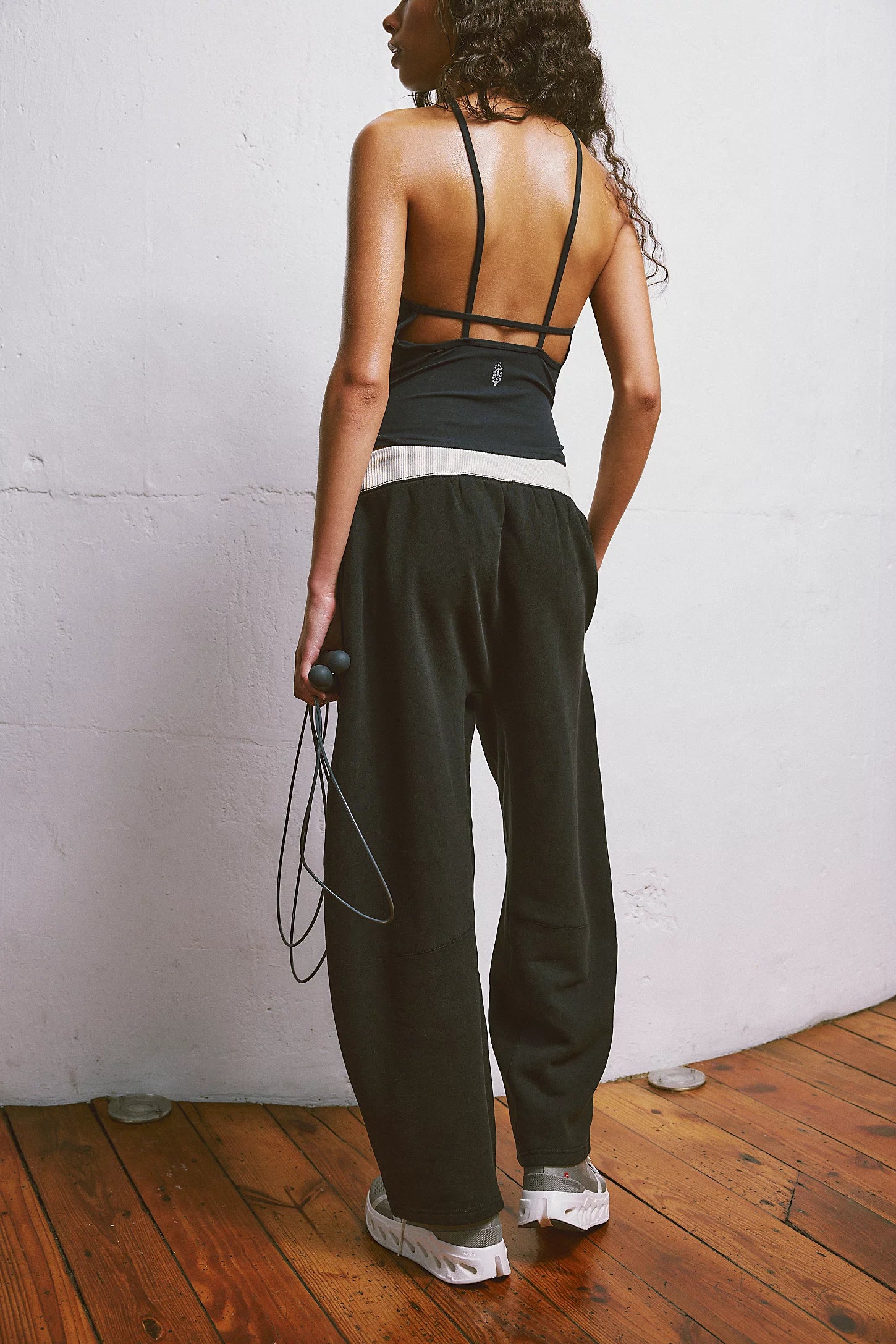 Free People You Wish Pant with a high-rise waist and unique barrel leg design, offering a comfortable and stylish look, Black