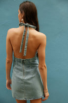 Free People Trevi Denim Mini Dress – a soft denim mini with a plunging halter neckline, defined bust cups, open back, and A-line silhouette, Celestial Blue