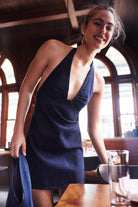Free People Trevi Denim Mini Dress – a soft denim mini with a plunging halter neckline, defined bust cups, open back, and A-line silhouette, Rinsed