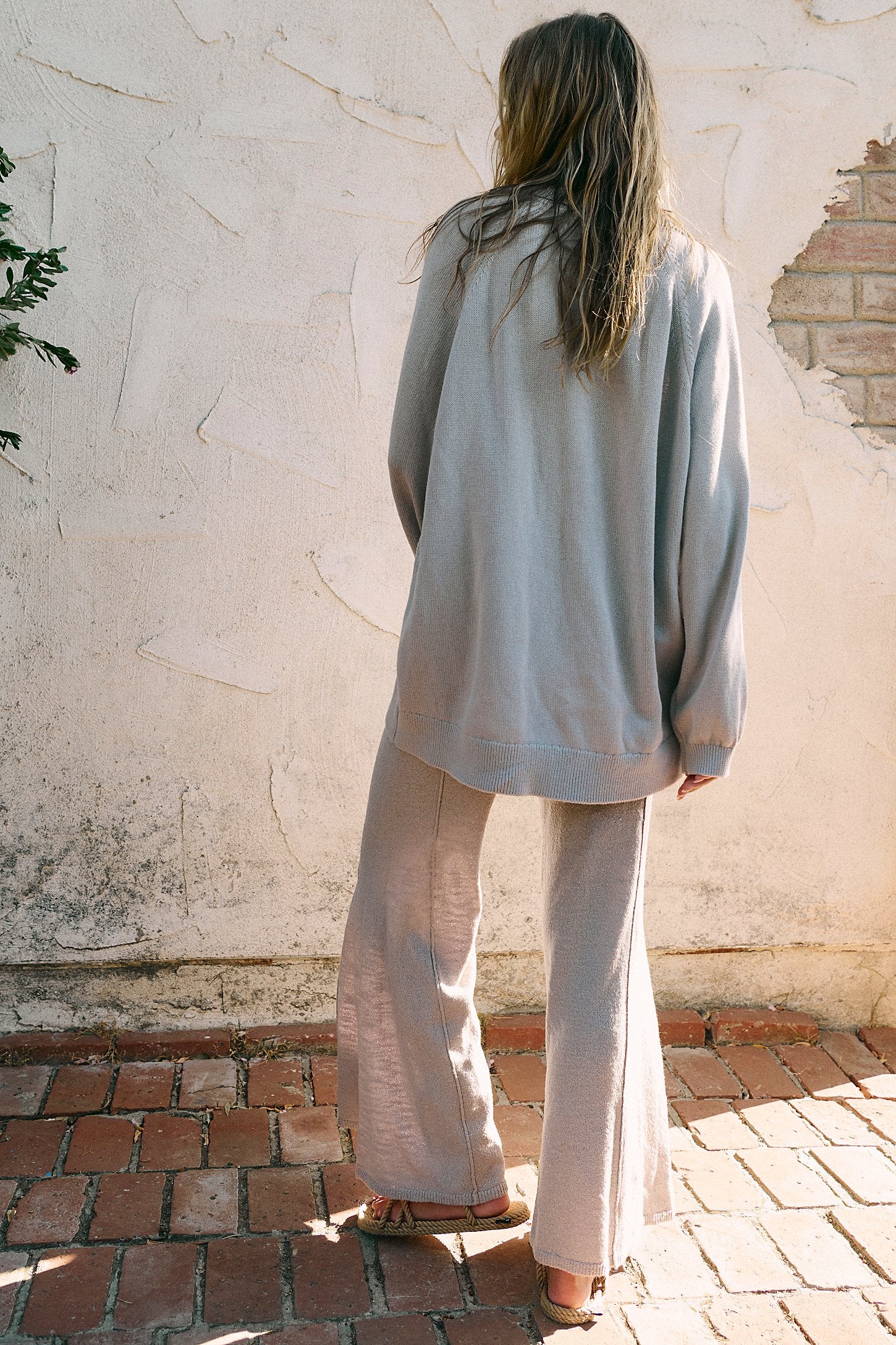 Free People Drea Sweater Set in a cozy knit fabric, featuring a relaxed-fit long-sleeve sweater and matching wide-leg pants, styled for a casual, comfortable look, Quiet Grey