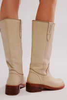 Free People Blaze Pull-On Boots featuring a tall silhouette, square toe, and stacked leather heel with distressed details, Parchment Leather