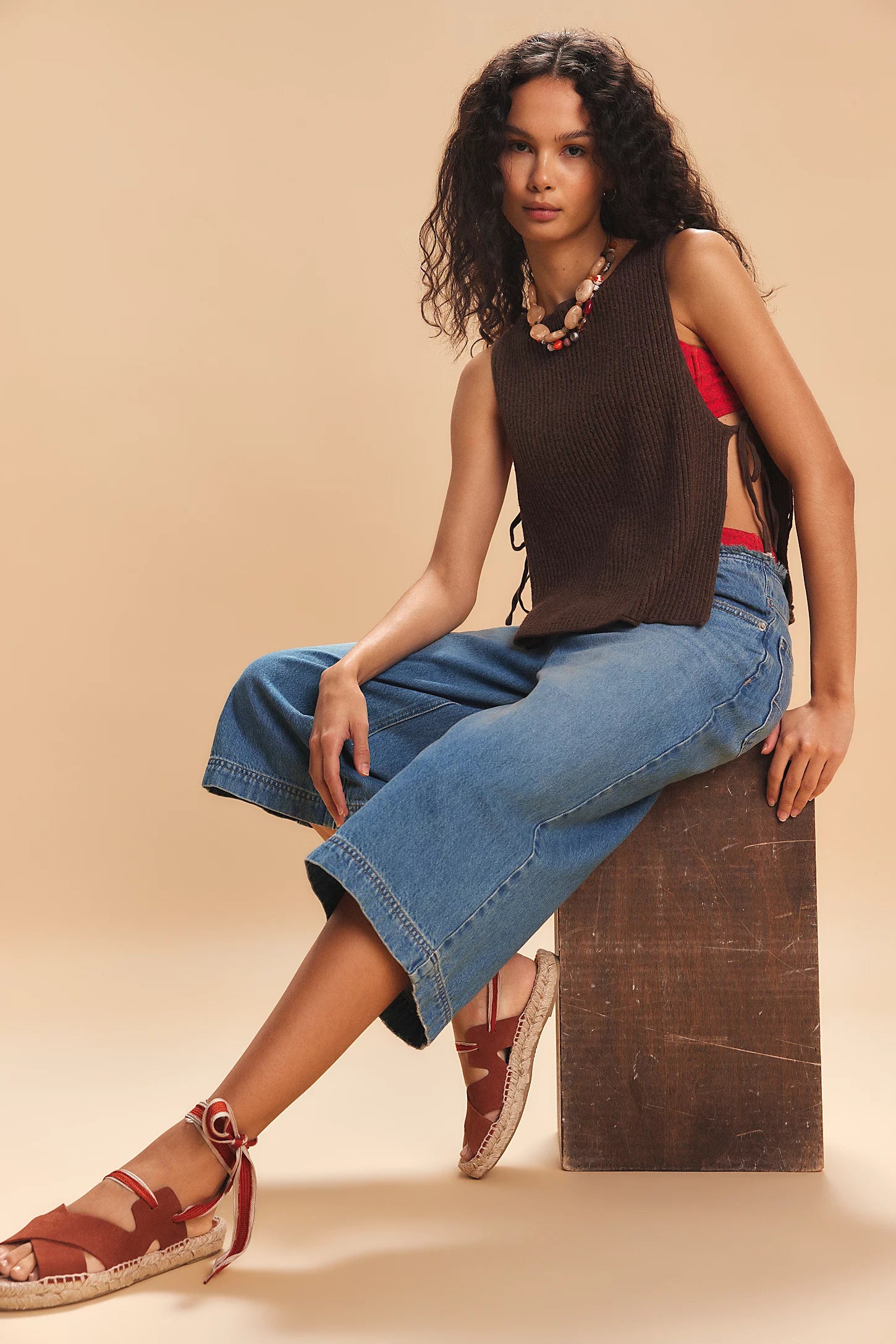 Free-est Lizzie Sweater Top — a relaxed, cropped knit top featuring a scoop neckline, ribbed texture, dropped armholes, and side tie closures for an airy, laid-back silhouette with a touch of playful detail, Carafe