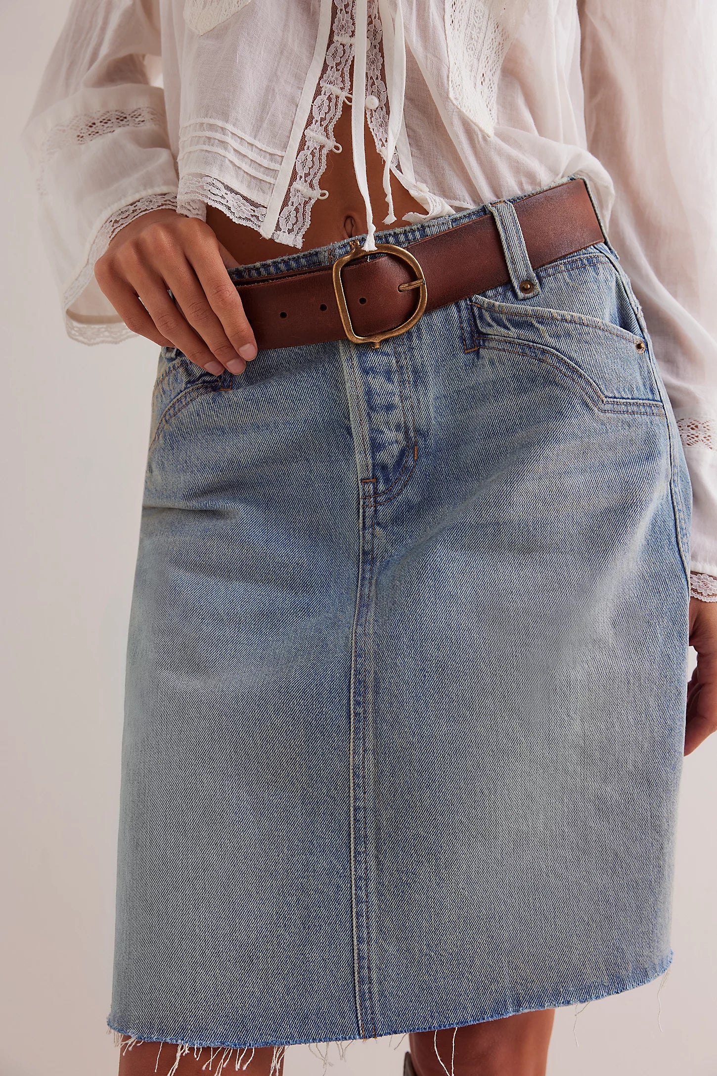 We The Free Denim Mini Skirt – a relaxed column-fit skirt with a zip fly, button closure, four-pocket styling, western-inspired yoke detailing, and frayed hemline, Sun Stoned Blue
